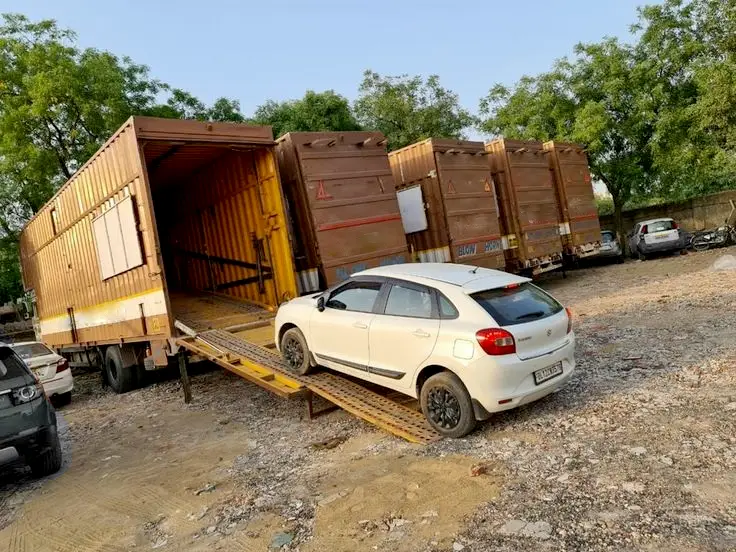 Car being loaded onto carrier for transport